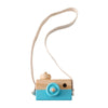 A wooden camera teether toy with a light blue body and a beige strap.