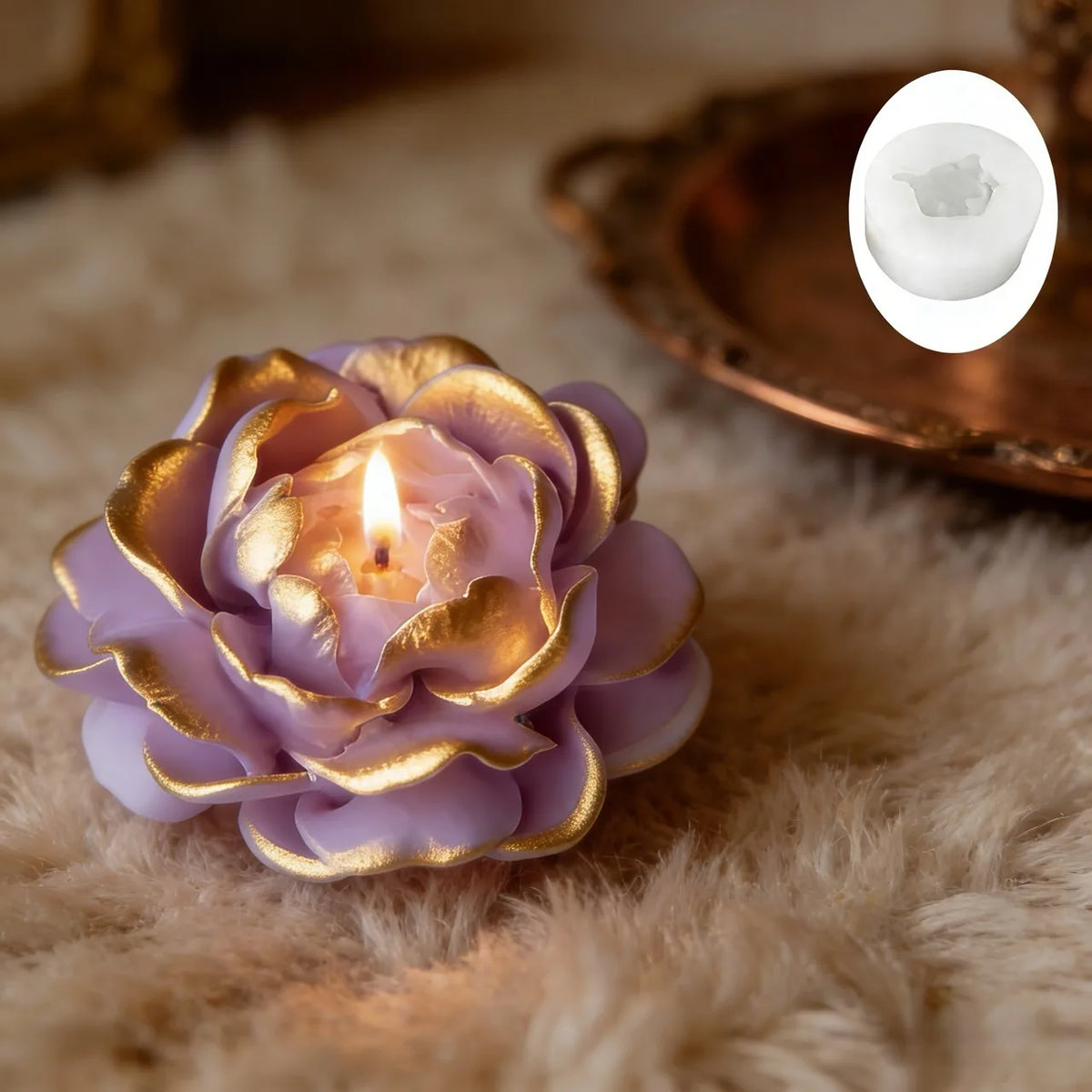 A purple silicone petal mold candle with a gold rim resting on a fluffy beige surface.