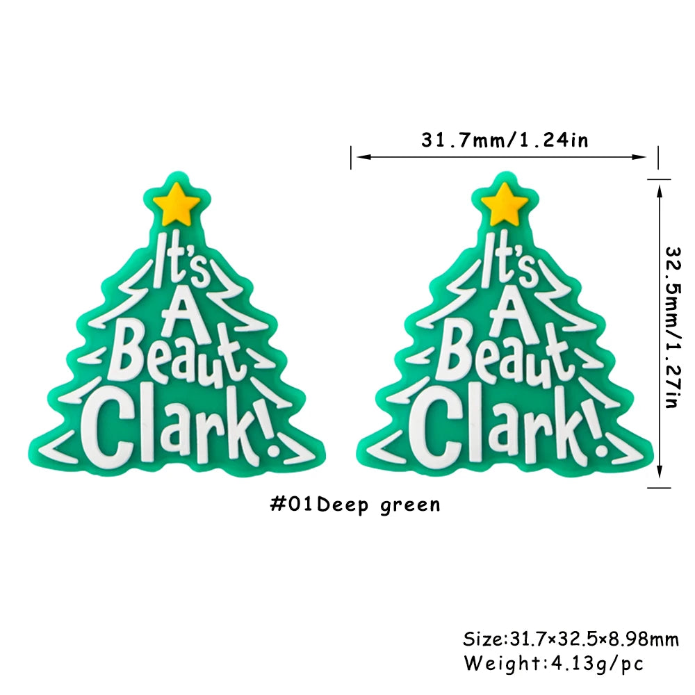 Deep green Christmas tree silicone bead with text It's A Beat Clark and a yellow star.