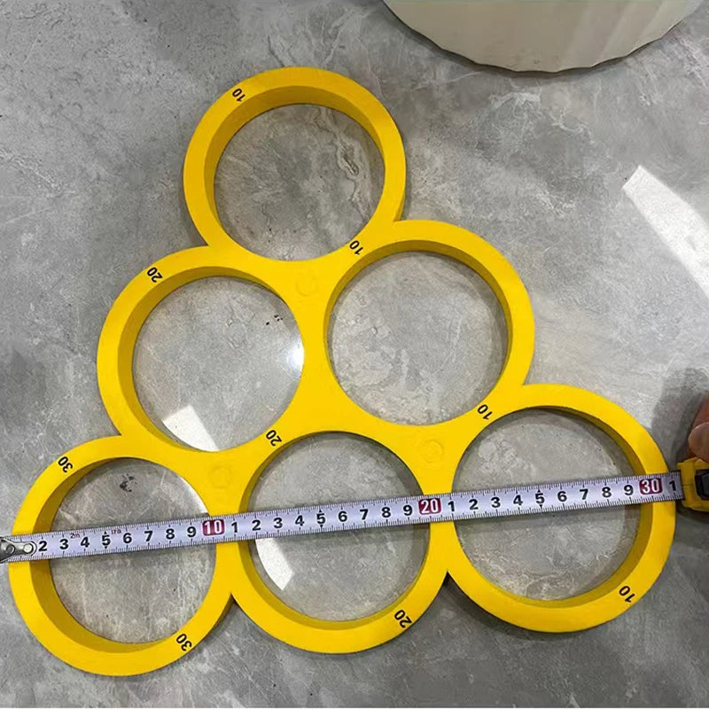 A yellow floating EVA pool ball organizer with ten circular compartments arranged in a honeycomb pattern.