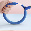 A hand holds a blue glowing ankle skip ball with a flashing LED light.