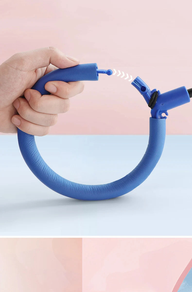 A hand holds a blue glowing ankle skip ball with a flashing LED light.