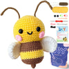 A yellow and brown crochet kit featuring an amigurumi bee with wings and yarn supplies.