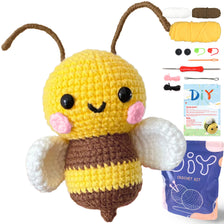 A yellow and brown crochet kit featuring an amigurumi bee with wings and yarn supplies.
