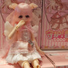 A pink-haired anime figure of a girl in a pink dress and wings is displayed in its box.