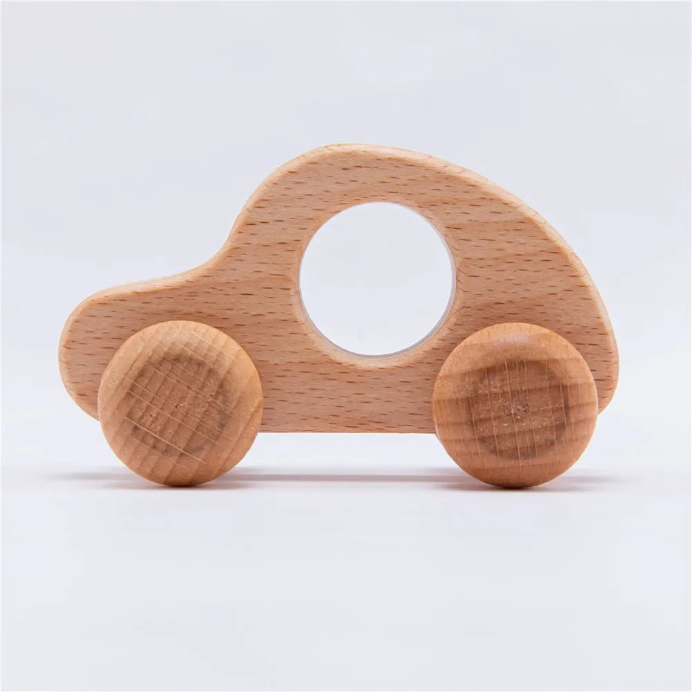 A wooden dinosaur toy car with a large hole for teething, made of light-colored wood.