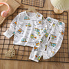 White kids cotton pajama set with a repeating pattern of yellow and blue construction vehicles