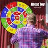 A person is playing a circular dart game with colored balls on a target board.