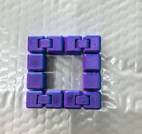 A purple infinity cube fidget toy made of interlocking plastic blocks.