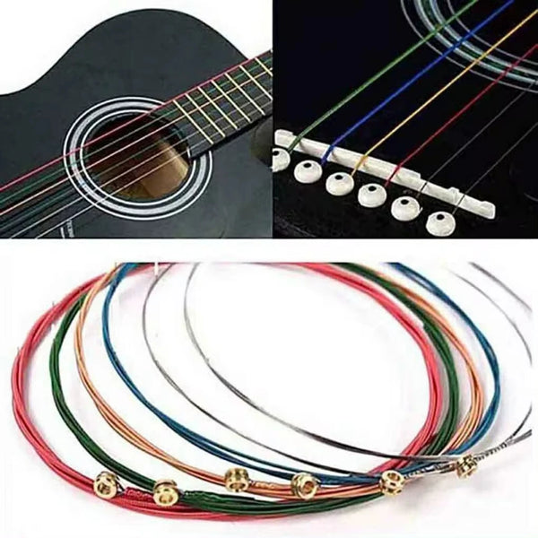 A set of six colored acoustic guitar strings, including red, green, blue, and yellow, laid out on a white background.