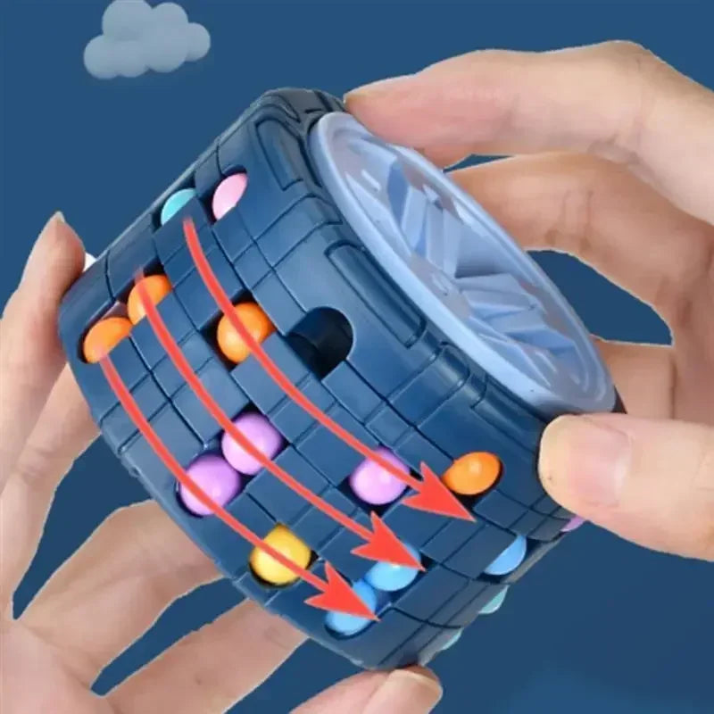 A hand is rotating a blue 3D slide puzzle cube filled with colorful plastic balls.