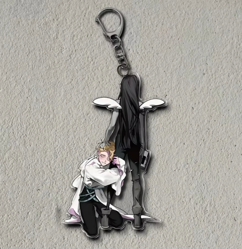 Acrylic figure stand of a character in a white coat and dark clothing with a hanging metal charm.