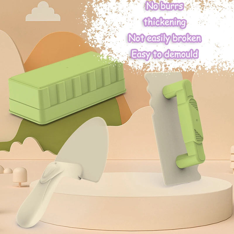 A green plastic tool is shown next to a white sand shovel and a piece of sand, demonstrating building tools for a beach sand 