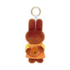 A small brown rabbit plush charm with a yellow polka-dot dress attached to a keyring.