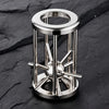 A multi-layer stainless steel puzzle cage brain teaser with a circular top and radiating spikes.