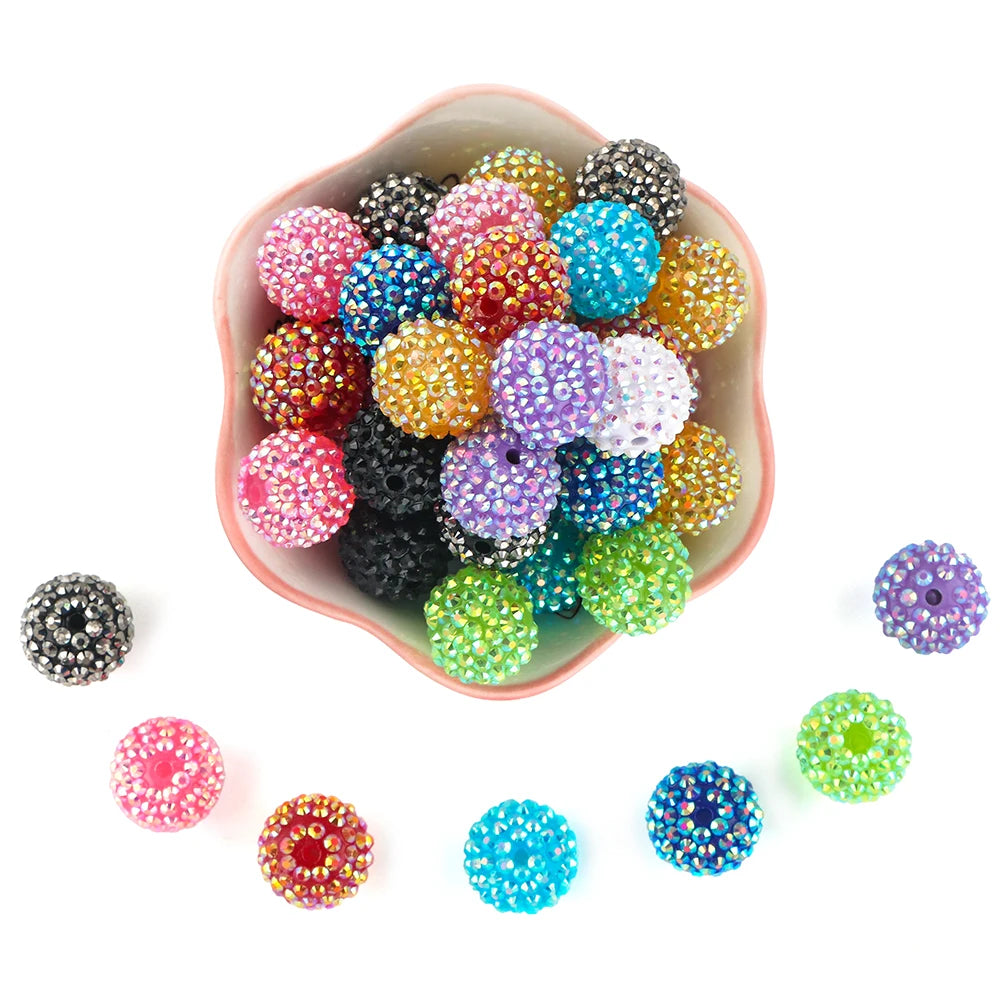 A bowl filled with colorful rhinestone resin bayberry beads for jewelry making