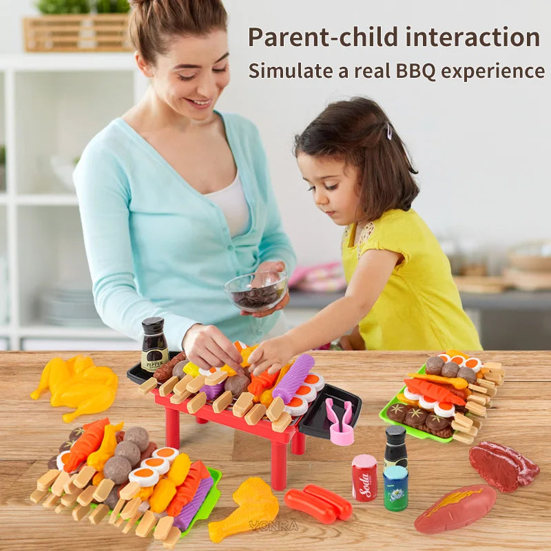 A child and parent interact with a mini barbecue pretend play set featuring various food items like sausages and vegetables.