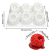 A white silicone mold set with six fruit shapes for baking and desserts, shown next to a piece of red fruit.
