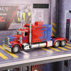 A red Peterbilt 389 diecast truck model with lights and sound displayed on a shelf.