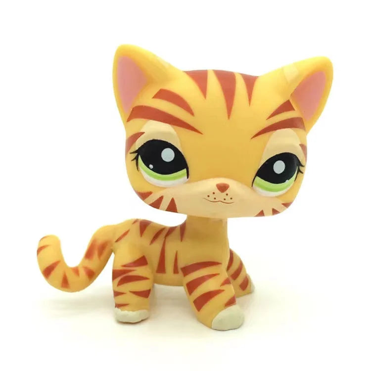 A yellow and orange striped kitten figure resembling a tiger, standing upright.