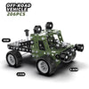 A green off-road vehicle model made of metal building blocks with large tires and an excavator-like structure.