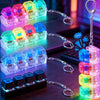 A collection of illuminated keychain toys featuring various colored buttons and keyboard-like components.