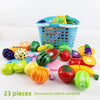 A colorful pretend play cutting food toy set with various fruits and vegetables stored in a blue shopping basket.