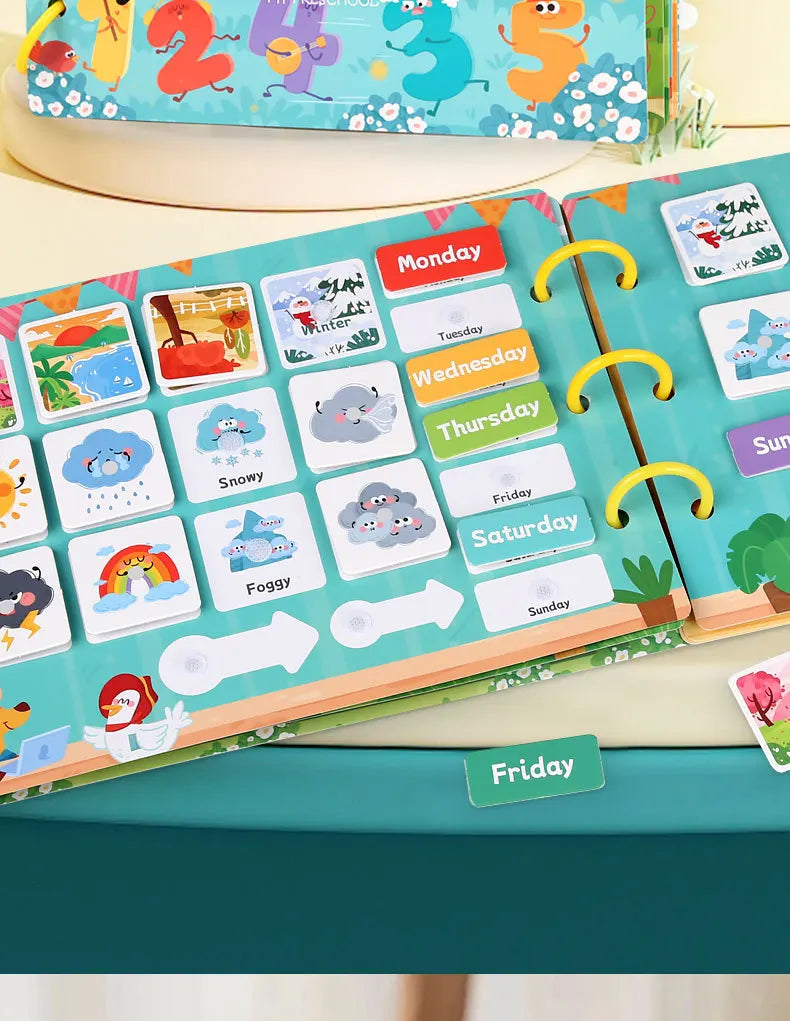 A colorful Montessori busy book featuring themed cards for days of the week and weather, displayed on a light wooden surface.