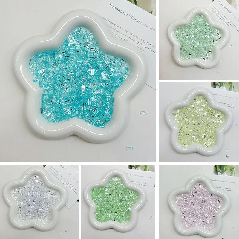 Various colors of iridescent acrylic ice strips used as filler for nail art and DIY crafts