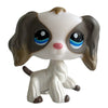 A white and brown pet figurine resembling a dachshund with large eyes and floppy ears.