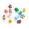 A collection of colorful poseable 3D printed animal figurines including a red lion, green frog, yellow tiger, and various oth