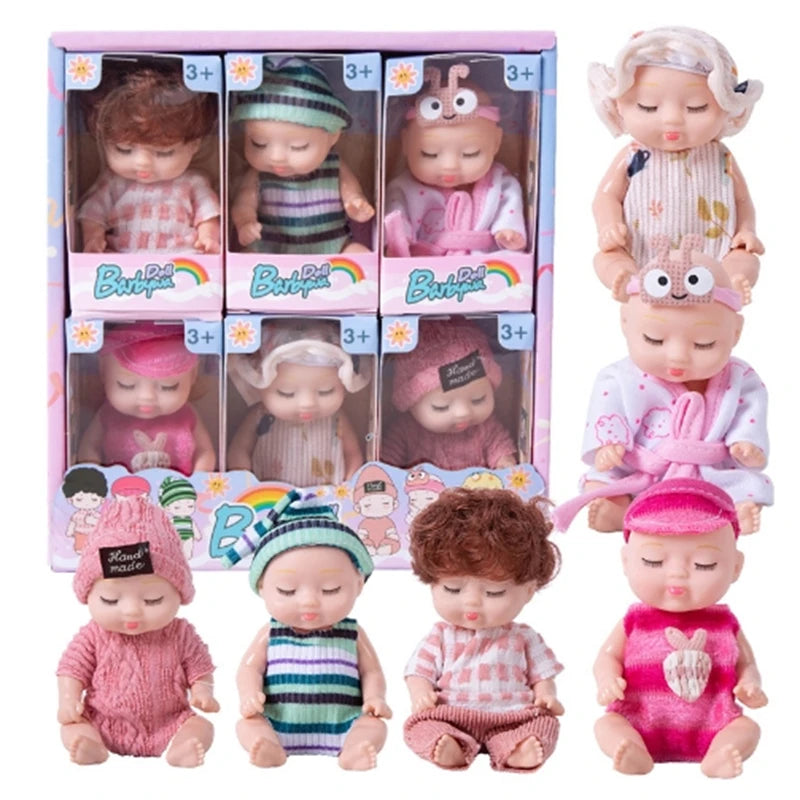A set of realistic mini reborn baby dolls with various outfits and accessories displayed in packaging.