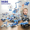 A boy is holding a blue and white motorized building block set featuring various vehicles and structures.