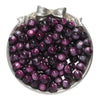 A pile of round, deep purple glitter cat eye resin beads in a silver-toned dish.