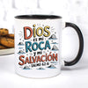 A white ceramic mug with a colorful Spanish Bible verse printed on it, featuring the text Dios es mi Roca y mi Salvación Salm