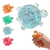 A collection of colorful squishy star turtle fidget balls, including orange, green, light blue, and pink varieties.