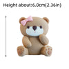 A light brown 3D bear cake topper with pink accents and a bow, shown from the front.