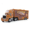 A die-cast toy hauler truck in orange and brown colors with a light-colored car graphic on the side.
