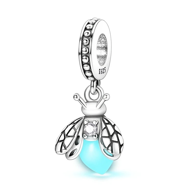 A sterling silver charm featuring a bee motif with a light blue gemstone bead.