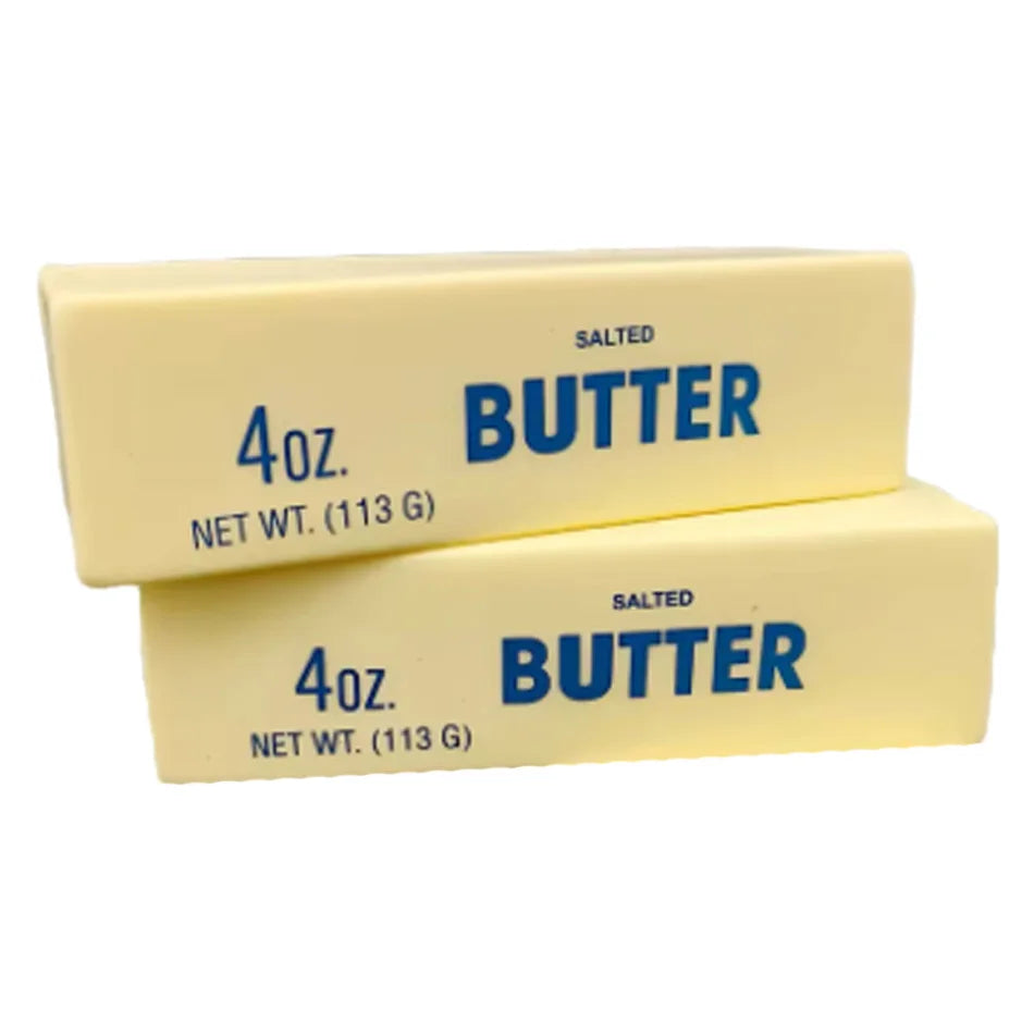 Two rectangular blocks of salted butter squishy stress relief toy labeled 4oz net wt 113 g