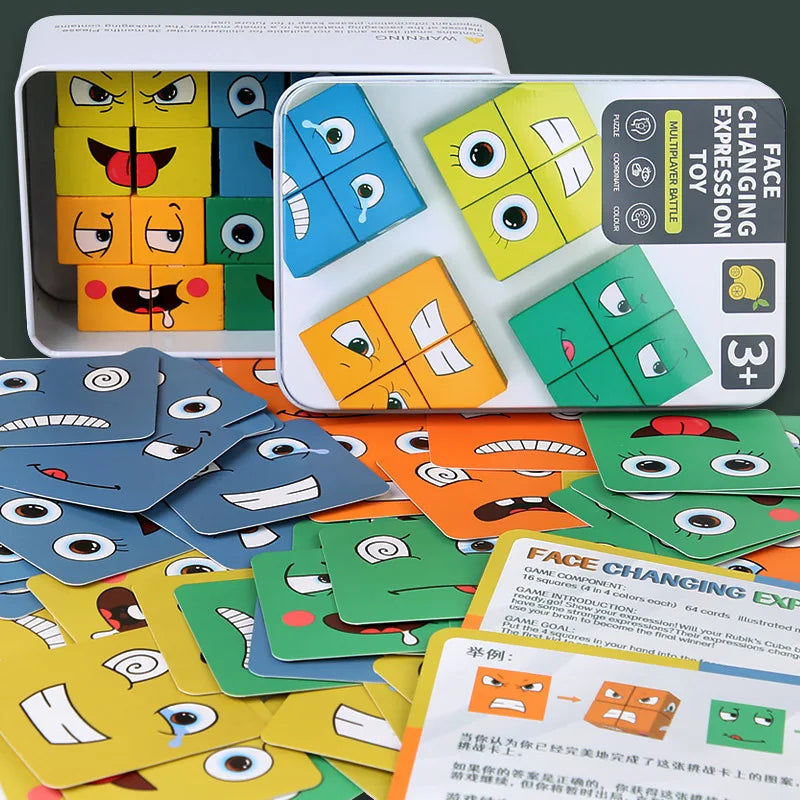 A box of wooden face-changing puzzle cubes and several loose game pieces showing various facial expressions.