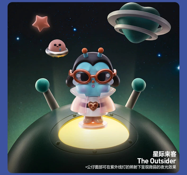 A collectible figurine of a crying baby astronaut with large glasses and a pink outfit floating above a dark space background
