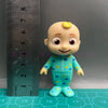 A cheerful cartoon figurine of a child wearing a blue and yellow polka-dot school uniform.