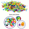 A pile of colorful fuse beads in various sizes, including 5mm and 2.6mm lengths.