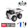 A white remote control construction excavator truck with a black cab and large tires, shown next to its controller and batter