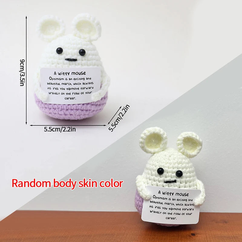 A white crocheted bunny doll with an inspirational quote tag on a light purple background.