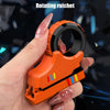 An orange rotating ratchet fidget toy is held in a hand against a dark background.