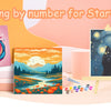 A painting by number kit featuring a unicorn and a black cat on canvas, displayed with paint and brushes.