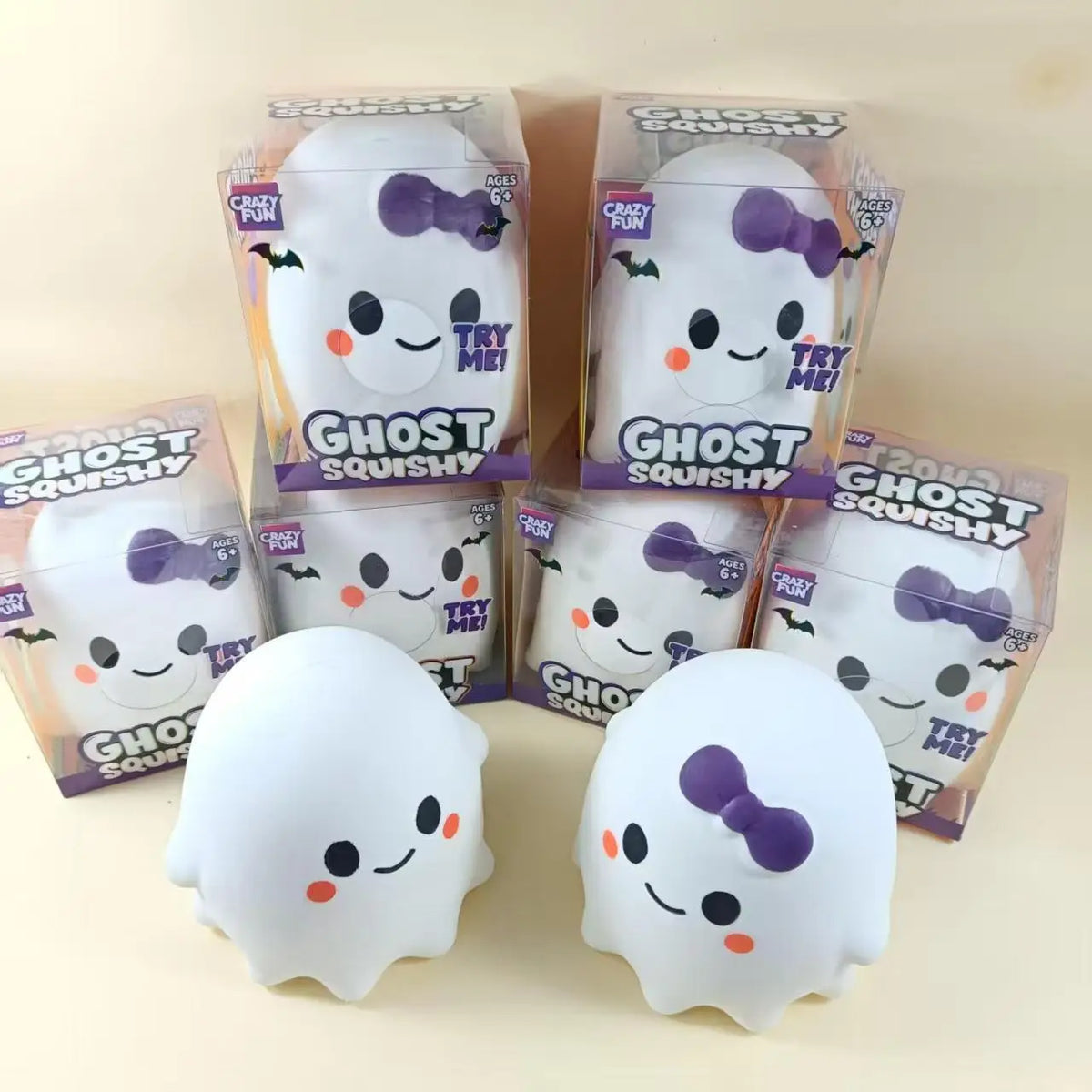 A collection of ghost squishy stress relief toys in clear packaging and loose, white ghost-shaped squishies with purple detai