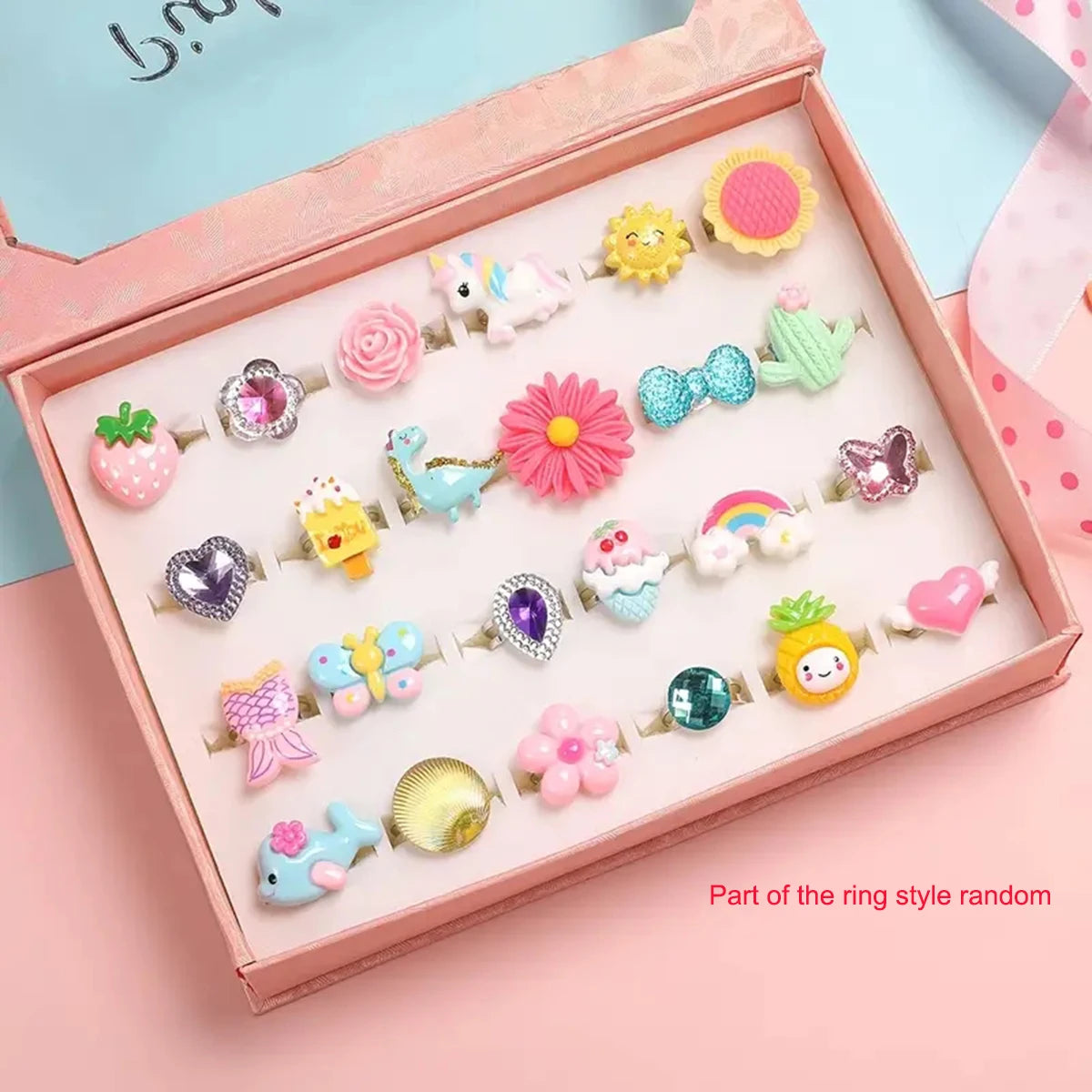 A pink box contains a collection of 24 sparkling gemstone rings and dress-up jewelry for girls.